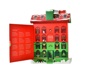 Opened English Tea Shop Christmas Tea House advent calendar revealing tasting notes panel and numbered calendar doors on a white background.