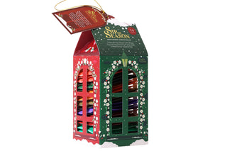 Front 3/4 view of English Tea Shop Lantern Assortment box showing red and green cut-out windows on a white background.