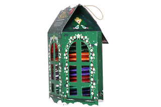 Side angle view of English Tea Shop green lantern tea box with sachet slots visible on a white background.