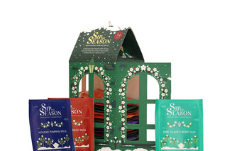 English Tea Shop Lantern Assortment box displayed with colorful individual tea sachets in front on a white background.