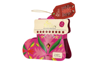 Angled front view of English Tea Shop pink Santa's Stocking organic tea gift box on a white background.
