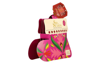 Side angle view of English Tea Shop pink Santa's Stocking tea box showing package thickness on a white background.