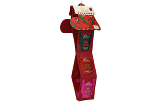 Angle view of English Tea Shop red Santa's Stocking opened into a vertical hanging display showing tea sachets.
