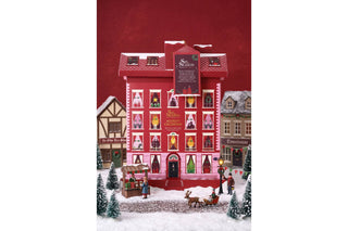 English Tea Shop Sip the Season Townhouse advent calendar box styled in a miniature snowy winter village scene.