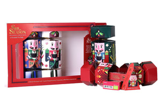 Open nutcracker-shaped festive tea cracker revealing organic pyramid tea bag inner boxes next to the main English Tea Shop gift packaging.