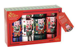 Three-quarter angle view of the red English Tea Shop festive organic tea gift box showing nutcracker-printed cracker boxes inside.